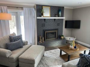 a living room with a couch and a fireplace at Inn On Lake Wissota in Chippewa Falls