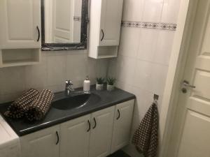 a bathroom with a sink and a mirror at Torill`s Apartment in Kragerø +17 photos