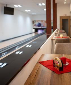 a bowling alley with a red napkin on a table at Turistická ubytovňa u Frajta in Telgárt