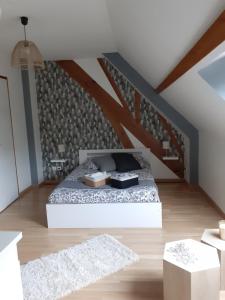 a bedroom with a bed in a attic at chambre chez habitant avec petit déjeuner in Bouloire