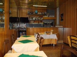 a restaurant with two tables with green napkins on them at Albergo Boccadasse in Genoa