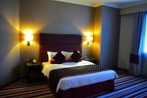 Een bed of bedden in een kamer bij Wonder Palace Hotel Qatar