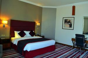 Een bed of bedden in een kamer bij Wonder Palace Hotel Qatar