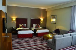 Een bed of bedden in een kamer bij Wonder Palace Hotel Qatar