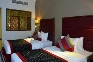Een bed of bedden in een kamer bij Wonder Palace Hotel Qatar
