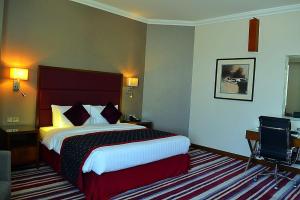 Een bed of bedden in een kamer bij Wonder Palace Hotel Qatar