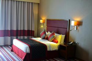 Een bed of bedden in een kamer bij Wonder Palace Hotel Qatar