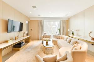 a living room with a couch and a tv at Five Palm Residences in Dubai