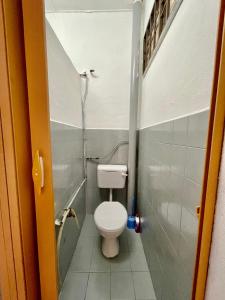 a small bathroom with a toilet and a shower at Cozy 255 Entire 3 Bedroom House At Alma Bukit Mertajam in Bukit Mertajam
