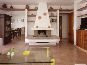 a living room with a fireplace with yellow dominoes on the floor at Holiday Home Mijas-Costa near Beach in La Cala de Mijas