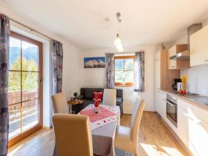 a kitchen and dining room with a table and chairs at Friendly apartment in a dream location in Going am Wilden Kaiser in Going
