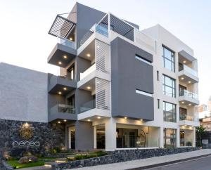 an apartment building with a white facade at Nerea Boutique Suites Karystos in Karistos