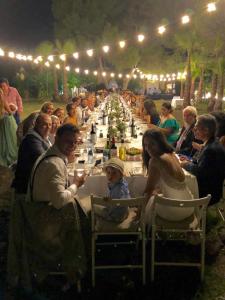 a large group of people sitting at a long table at Casa Nova Estate in Sitges