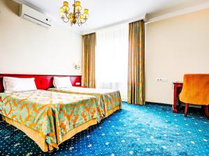 a hotel room with a bed and a desk at Parisel Palace Centrum Konferencyjno-Wypoczynkowe Klimki pod Łukowem in Łuków