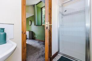 a bathroom with a shower and a sink at Finest Retreats - Idris Barn Helm y Llwyn Barn in Dolgellau +31 photos