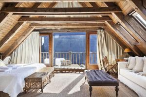 a living room with a couch and a large window at Luderna - Casa Sendrosa in Gessa