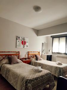 Un pat sau paturi într-o cameră la PENSIÓN PESQUERO