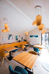 a restaurant with tables and chairs and lights at L'envie in Saint-Gilles-Croix-de-Vie