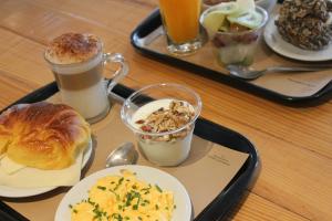 a tray of breakfast foods and drinks on a table at RM The Experience - Small Portuguese Hotels in Setúbal