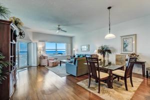 a living room with a dining table and a living room at Ocean View Arcane Condo in Fernandina Beach