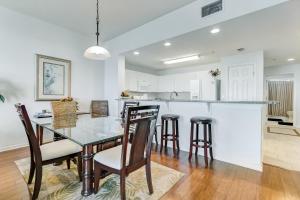 a dining room and kitchen with a glass table and chairs at Ocean View Arcane Condo in Fernandina Beach