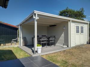 a shed with a table and chairs in it at Seaside in Middelkerke
