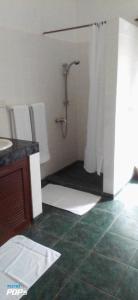 a bathroom with a shower and a sink at Diani Horizon Beach Cottages in Diani Beach