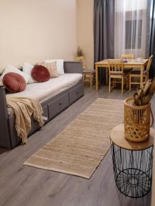 a living room with a couch and a table at Mi Casa Vendégház - Apartments in Eger