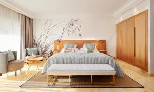 a bedroom with a large bed and a living room at Grupotel Parc Natural & Spa in Playa de Muro