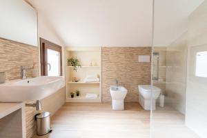 a bathroom with a sink and a toilet at Lumen House in Sassari