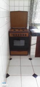 a stove in a kitchen with a tiled floor at Diani Horizon Beach Cottages in Diani Beach