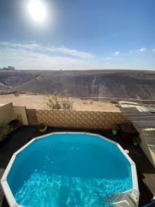 a swimming pool with a view of the desert at Desert Pearl Arad in Arad