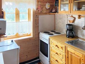 a kitchen with a white stove top oven next to a window at 4 person holiday home in HARDBAKKE-By Traum in Hardbakke