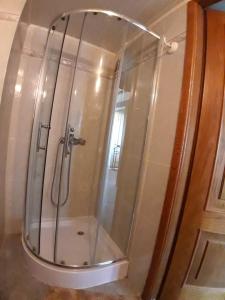 a shower with a glass door in a bathroom at Hotel Turist in Chişinău