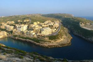 an aerial view of a city next to a body of water at Seafront Penthouse with Terrace in Xlendi, Gozo in Xlendi