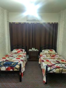 Säng eller sängar i ett rum på Mamaya Hotel