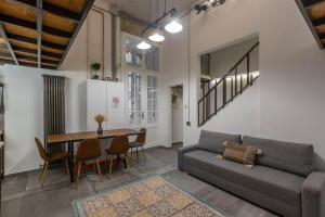 a living room with a couch and a table at The Address Loft 22ppl in Budapest