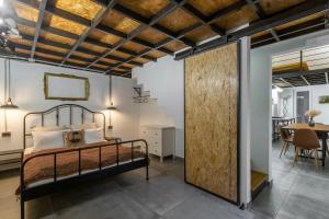 a bedroom with a bed and a dining room at The Address Loft 22ppl in Budapest