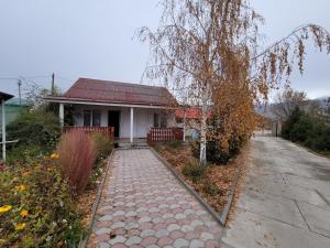 a house with a walkway in front of a house at Ай-Ас in Cholpon-Ata
