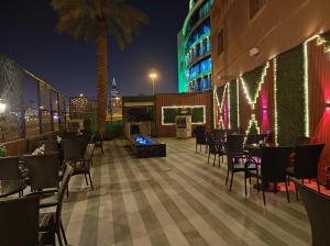 a restaurant on the rooftop of a building at night at Burj Al Hayat Hotel Suites - Al Olaya in Riyadh