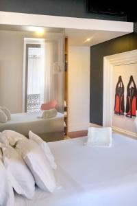 a bedroom with two beds with white pillows at RM The Experience - Small Portuguese Hotels in Setúbal