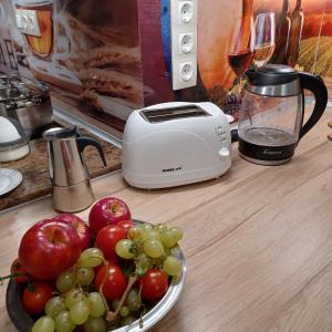a toaster and a plate of fruit on a counter at Corner Apartment in Budapest