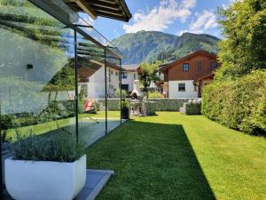 a garden with a view of a house at Ferienwohnung Katharina in Hollersbach im Pinzgau