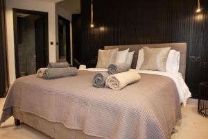 a bedroom with a large bed with towels on it at Raam Luxury Suites in Larnaca