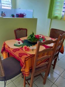 a dining room table with a bowl of flowers on it at Appartement de 2 chambres avec balcon et wifi a Sainte Marie a 6 km de la plage in Sainte-Marie
