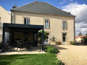 a large stone house with a large garage at Maison Marie Barrault in Les Herbiers