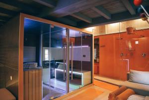 a glass shower in a room with a couch at Maison Farinet in Saint-Rhémy-en-bosses