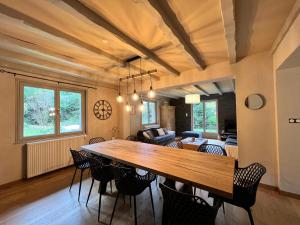 a dining room with a large wooden table and chairs at LES CIMES BLANCHES CLEDICIHOME Chalet 10 pers SPA & Grand terrain 4 MINUTES DES PISTES in La Bresse