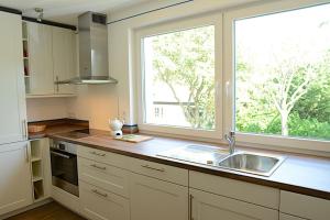 a kitchen with a sink and a large window at La Mer Whg 03 in Wyk auf Föhr