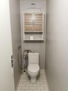 a small bathroom with a toilet and a cabinet at Chambre privée chez habitant à 2 pas de la gare in Blois